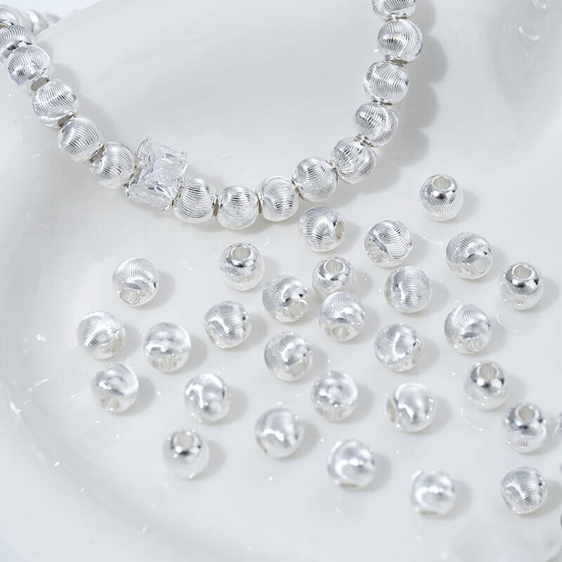 Fine patterned cat's eye faceted round beads with brushed spacer beads