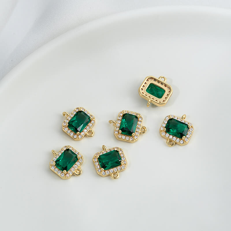 Geometric double ring with emerald and olive green zircon