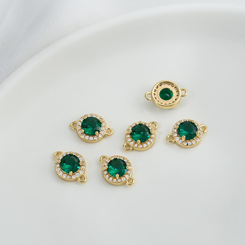 Geometric double ring with emerald and olive green zircon