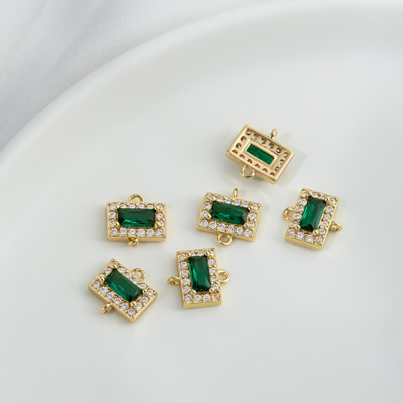 Geometric double ring with emerald and olive green zircon