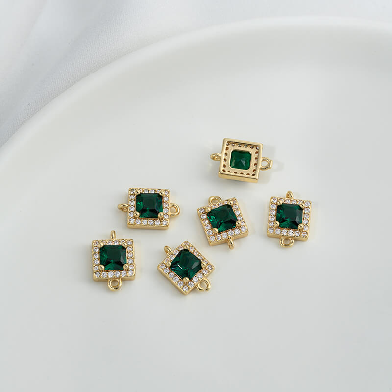 Geometric double ring with emerald and olive green zircon