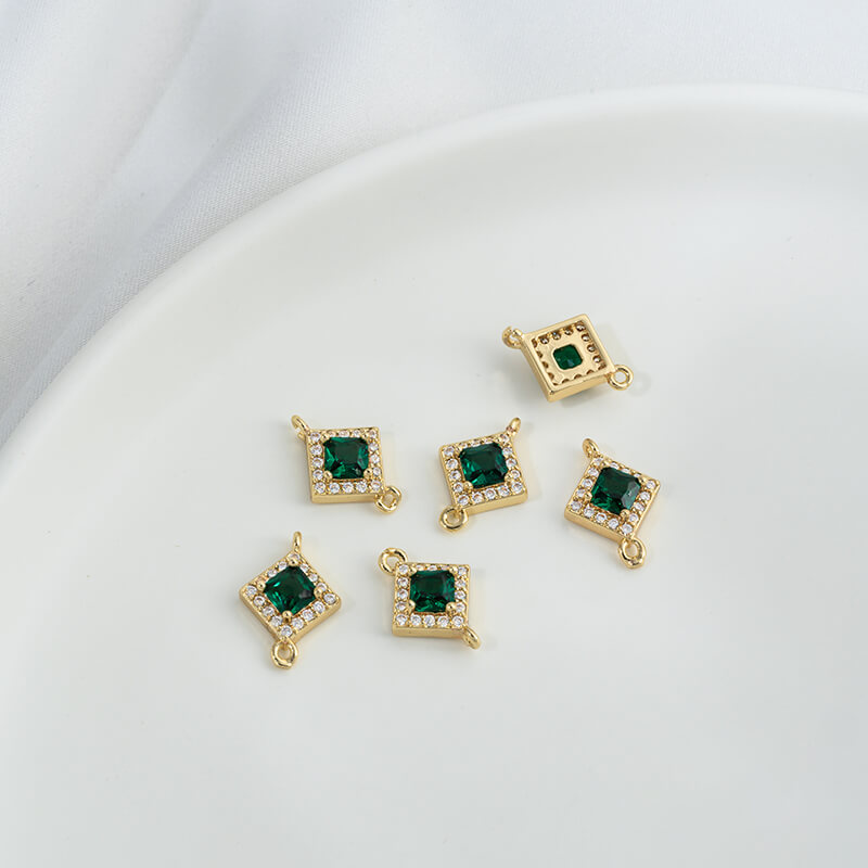Geometric double ring with emerald and olive green zircon