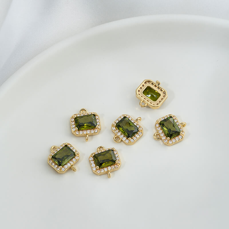 Geometric double ring with emerald and olive green zircon