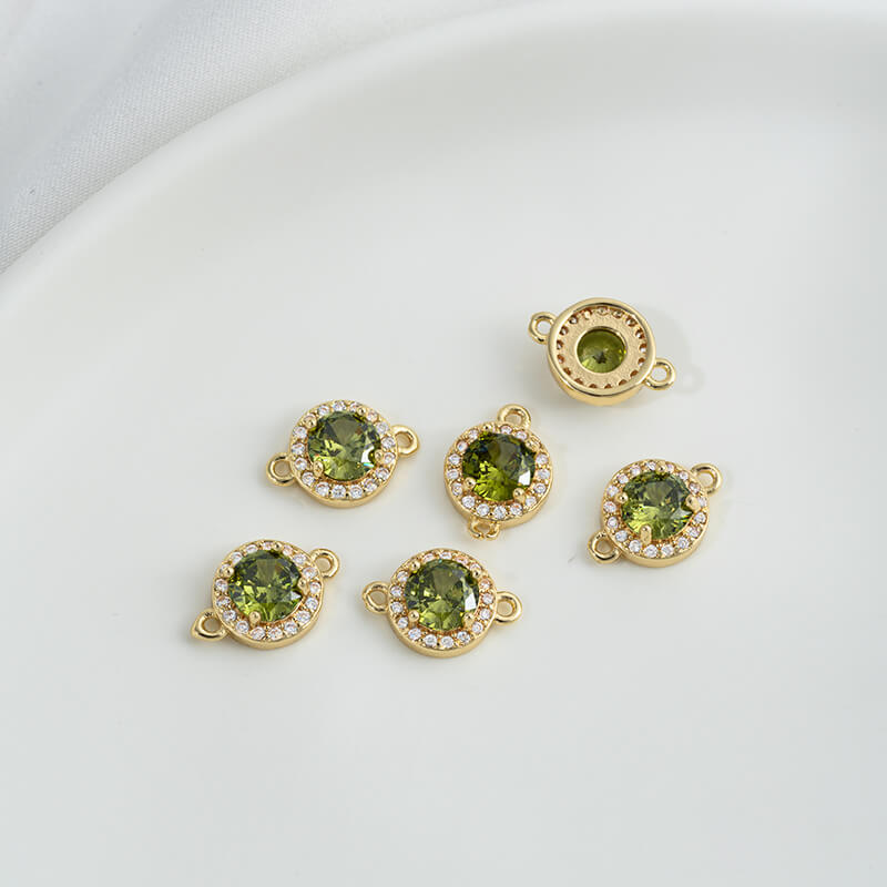Geometric double ring with emerald and olive green zircon