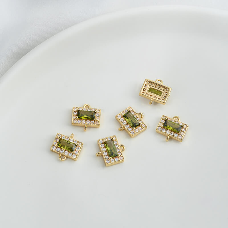 Geometric double ring with emerald and olive green zircon