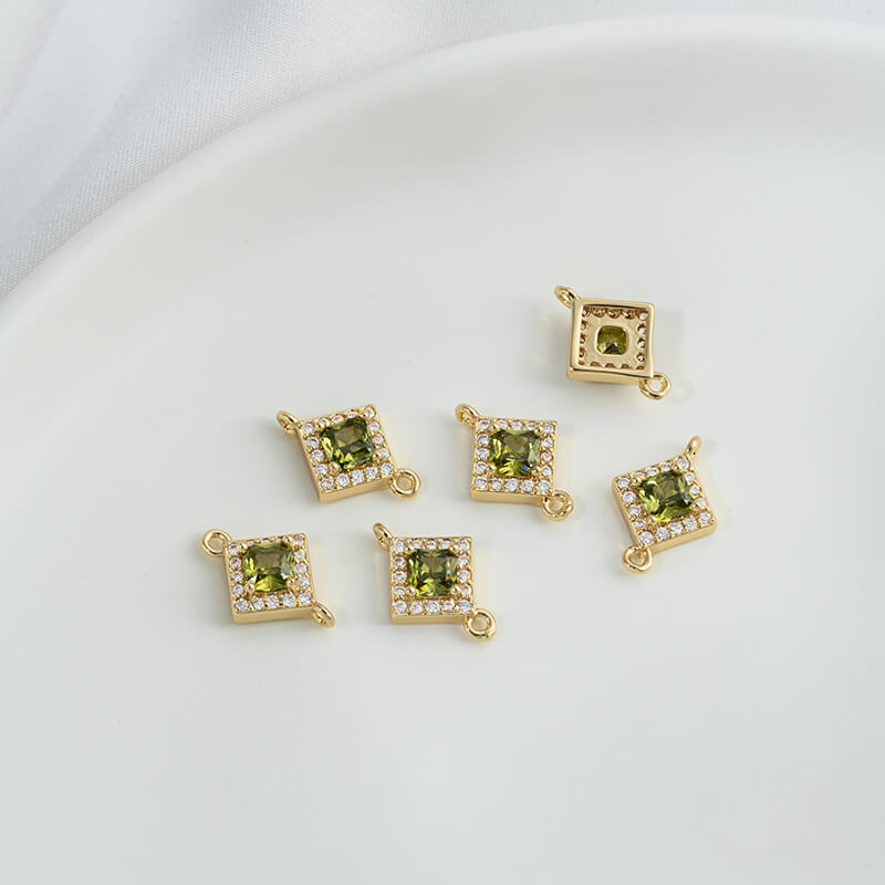 Geometric double ring with emerald and olive green zircon