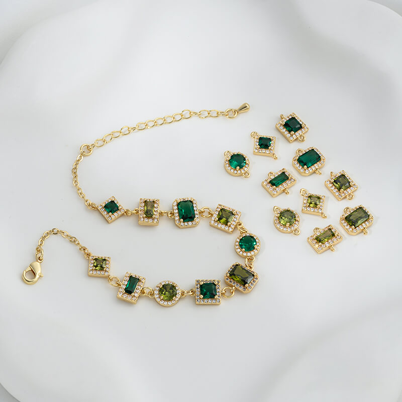 Geometric double ring with emerald and olive green zircon