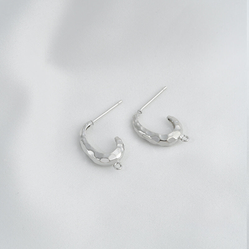 C-shaped lava earrings with hanging rings and diamond-faced earrings