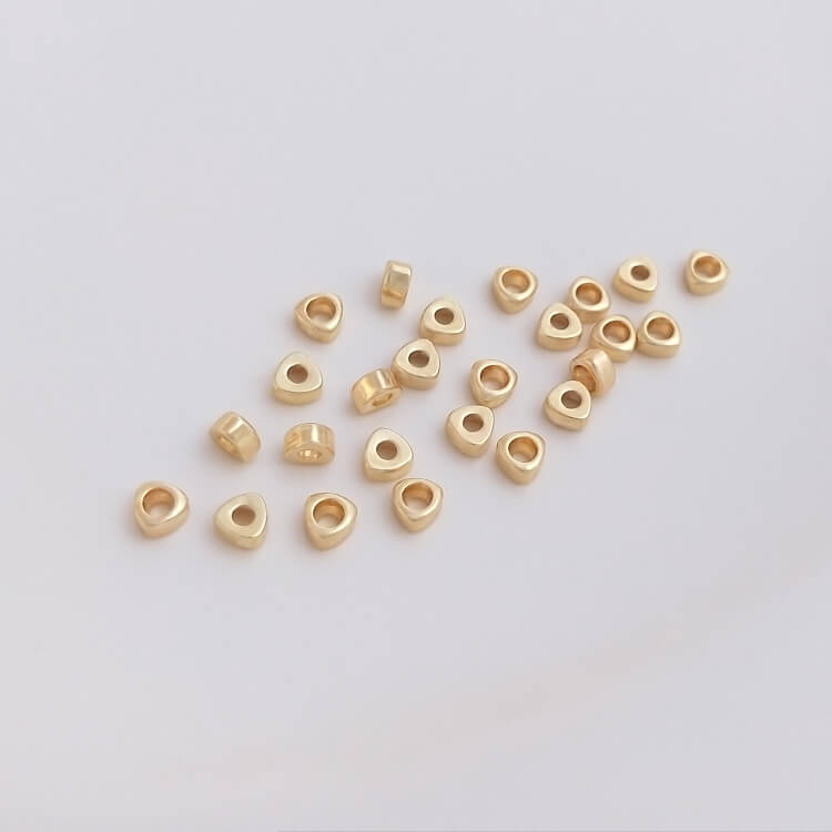 Triangular small gold spacer beads