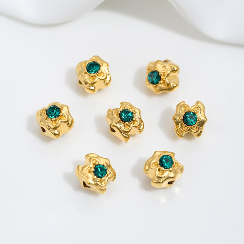 Sand gold inlaid with ruby and green diamonds, spacer beads