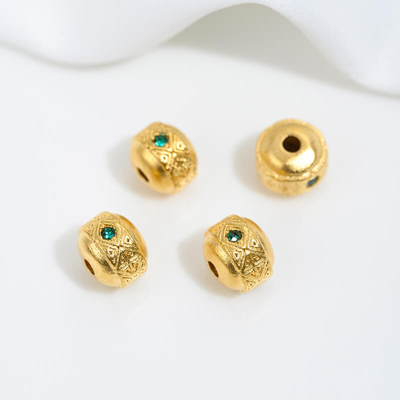 Sand gold inlaid with ruby and green diamonds, spacer beads