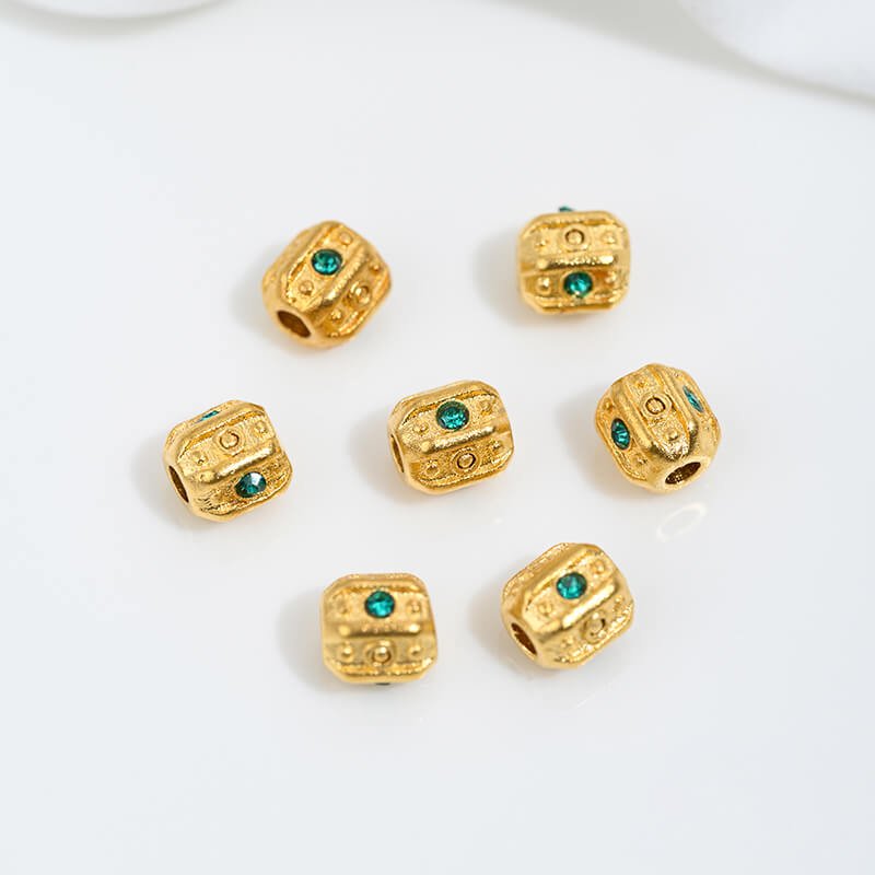 Sand gold inlaid with ruby and green diamonds, spacer beads