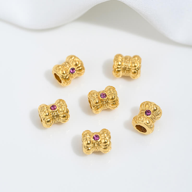 Sand gold inlaid with ruby and green diamonds, spacer beads