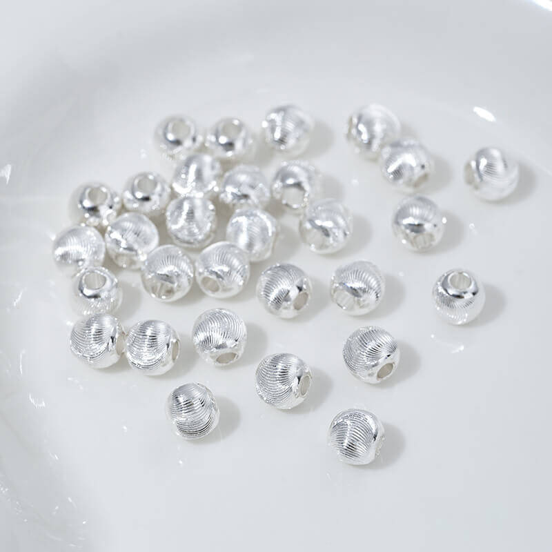 Fine patterned cat's eye faceted round beads with brushed spacer beads